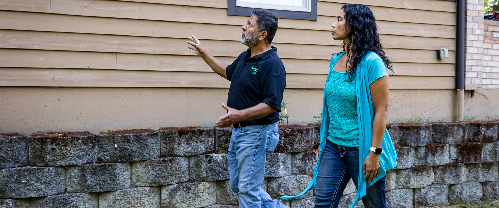 Ziply Fiber technician talks to a client about the fiber technology on their property. 