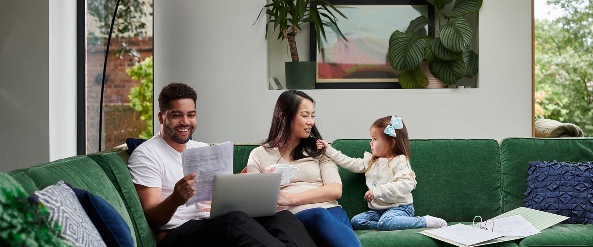 Family on a couch enjoying fiber internet, the gold standard for internet speed and reliability. 