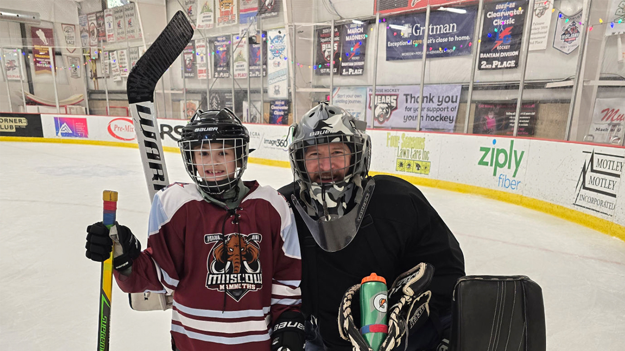 Two happy hockey players that are enjoying the rink that is sponsored by Ziply Fiber