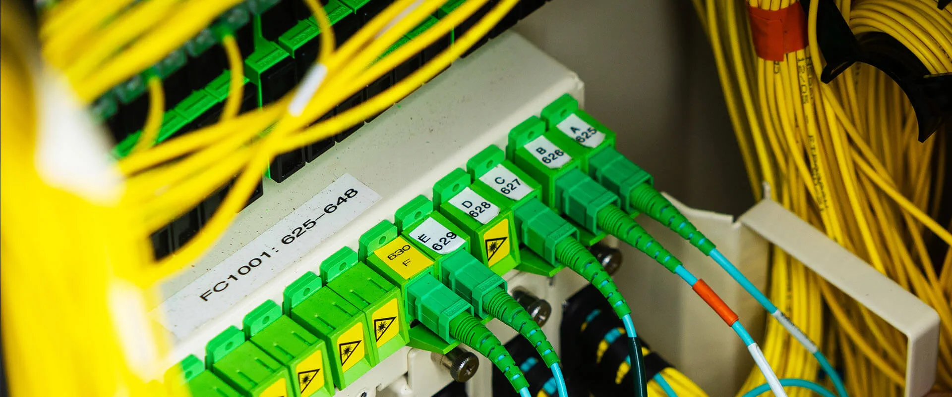 Close-up photo of multiple fiber-optic cables connected and delivering lightening fast internet. 