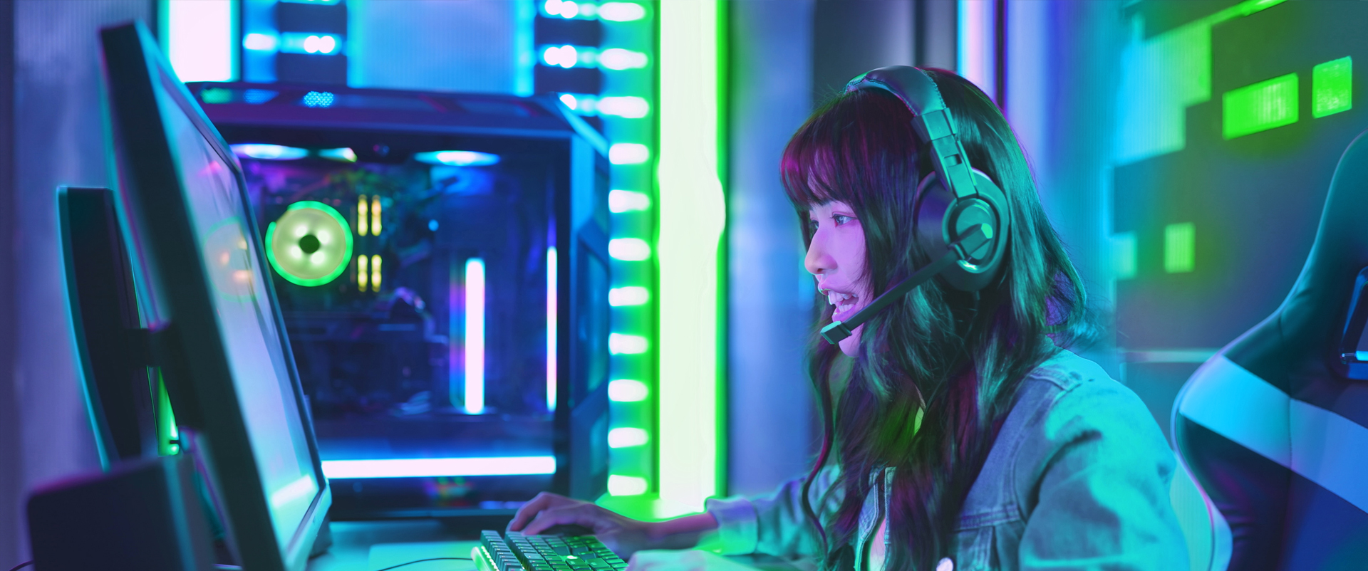 Person wearing a gaming headset in front of monitor 