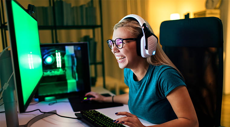 Person at their computer with headphones excitedly using 10 gig fiber