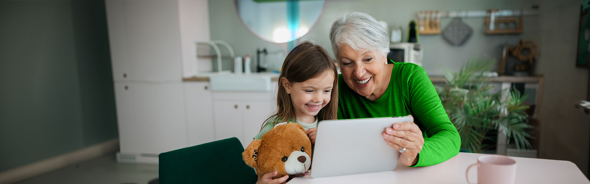 Grandma and granddaughter search for donation site on a tablet connected to Ziply Fiber WiFi 