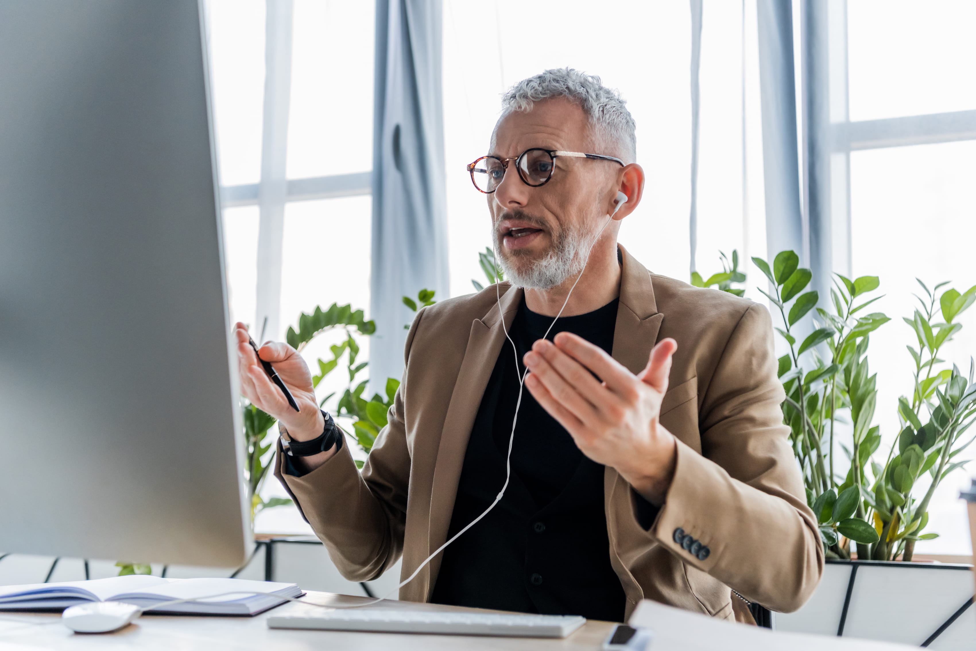 Gen X professional in a blazer in a virtual meeting using business fiber internet
