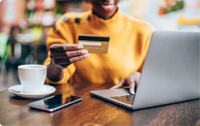 Person with credit card and computer