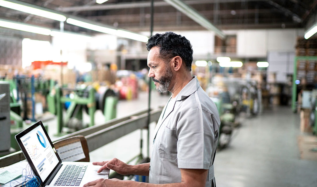 1 person using a laptop in warehouse