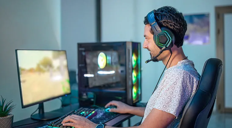 Person with headphones gaming on their PC while using Ziply Fiber’s multi-gig internet