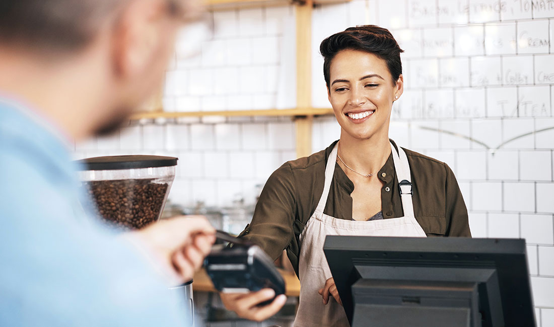 person with apron and POS